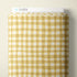 A bolt of fabric with a yellow and white gingham check pattern, displayed against a light beige background. A white header card at the top features the brand name 'CLOUD9' with a small blue cloud logo.