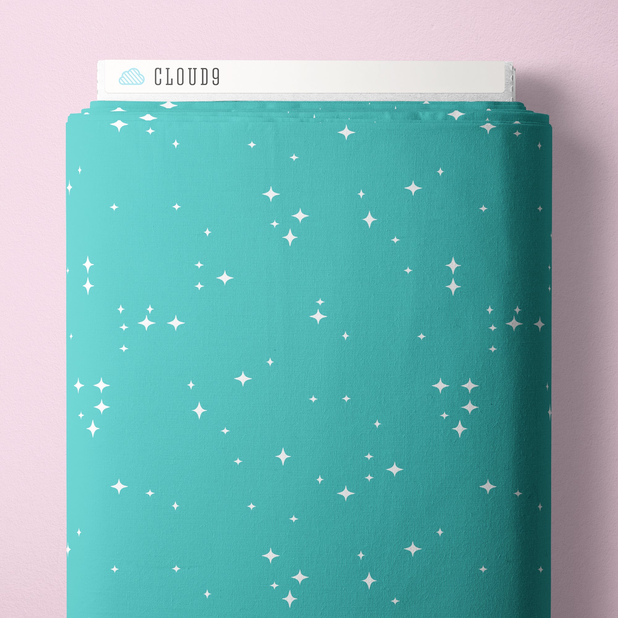 Teal fabric bolt with star pattern on a pink background, featuring the brand 'Cloud9'.