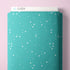 Teal fabric bolt with star pattern on a pink background, featuring the brand 'Cloud9'.