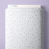 A roll of white fabric with a repeating pattern of small purple stars and sparkles, shown against a light purple background. The brand name 'CLOUD9' is visible on the top edge of the fabric roll.