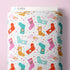 Fabric bolt with colorful sock design on a pink background
