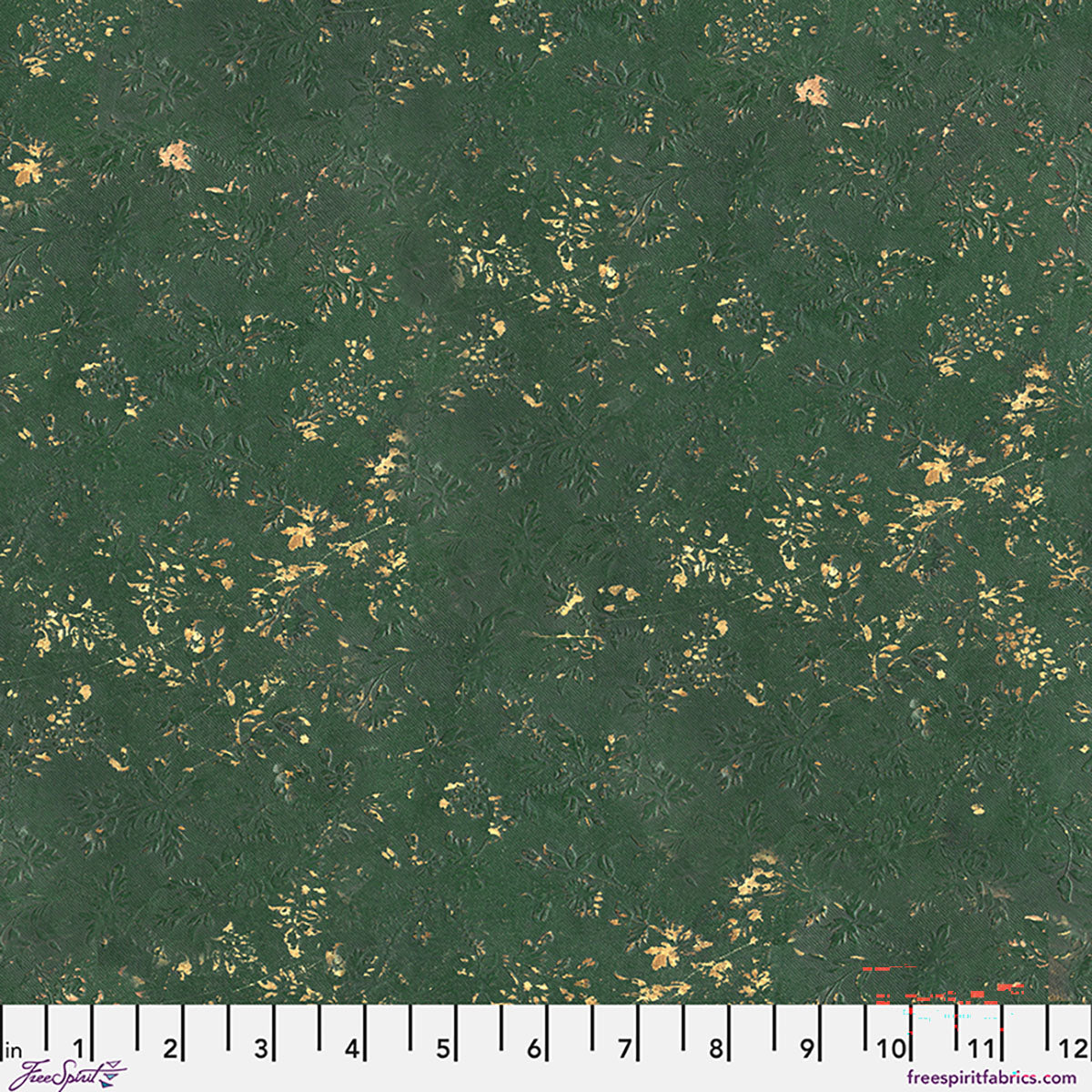 Green fabric with gold speckles and a ruler at the bottom for scale.
