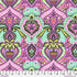 Colorful patterned fabric with geometric shapes and vibrant colors, displayed on a ruler for scale.