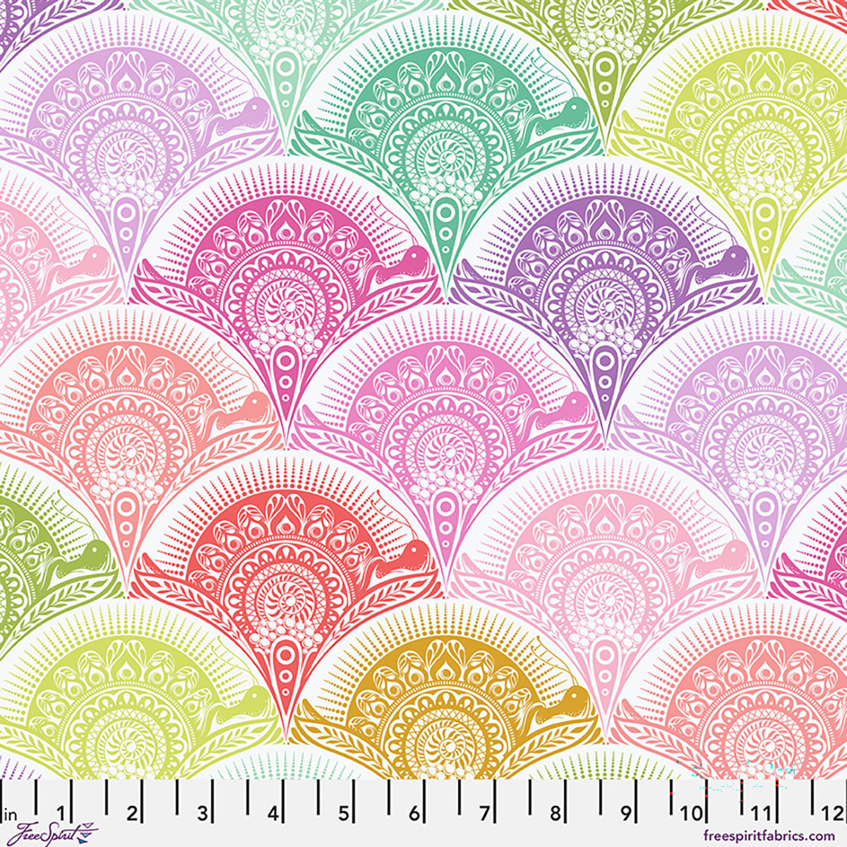 A repeating fabric pattern featuring scalloped fan shapes in pastel rainbow colors with intricate mandala-style detailing, shown on a white background with a ruler along the bottom for scale.