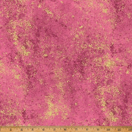 Pink fabric with gold speckles and a ruler at the bottom for scale.