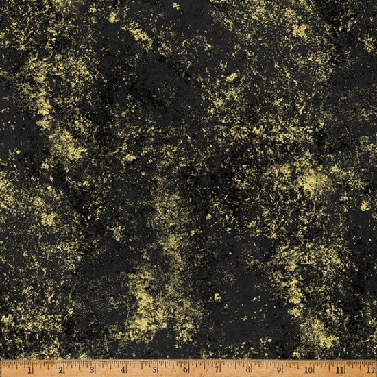 Textured gold and black fabric with a ruler at the bottom for scale.
