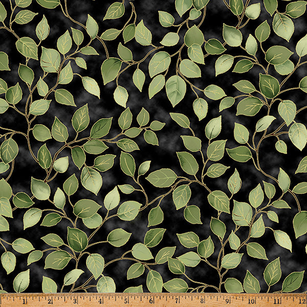 Green leaf pattern on black fabric with a ruler at the bottom for scale.