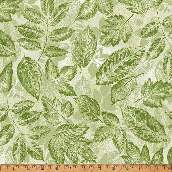 Green leaf fabric on a light background with a wooden ruler at the bottom.