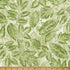 Green leaf fabric on a light background with a wooden ruler at the bottom.