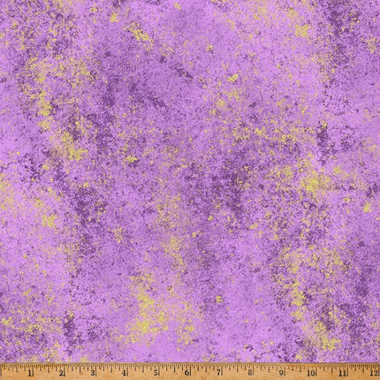 Purple fabric with yellow speckles and a ruler at the bottom for scale.