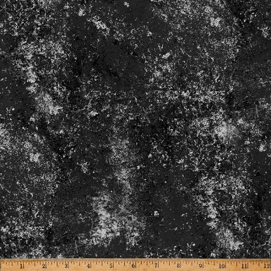 Textured black and gray fabric with a ruler at the bottom for scale.