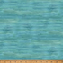 A close-up of a fabric with a watercolor-like textured design in shades of teal, blue, and green, with a wooden ruler along the bottom edge showing measurements.