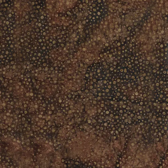 A close-up of a textured fabric featuring a dense field of small, scattered gold and beige dots over a mottled dark brown and black background.