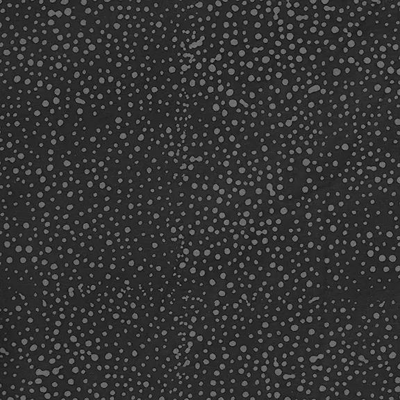 A close-up of a dark charcoal gray fabric with an allover pattern of small light gray dots.