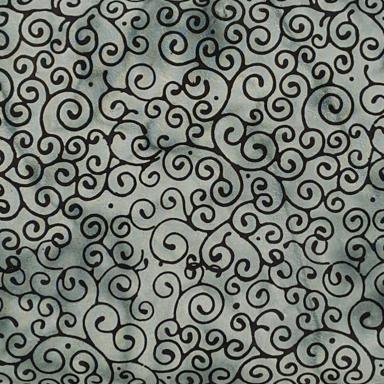 A close-up of a fabric with a repeating black ornamental swirl pattern on a muted gray-green background.