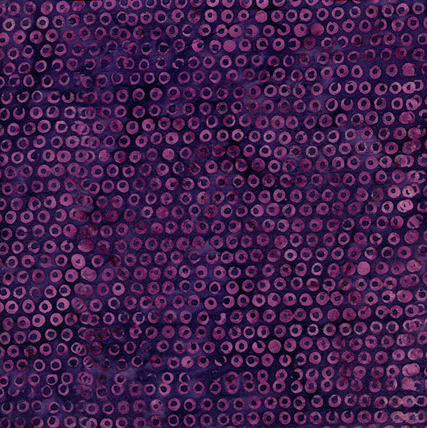 Close-up of a textured purple fabric with a circular pattern