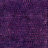 Close-up of a textured purple fabric with a circular pattern