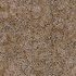 A close-up of a batik fabric pattern featuring a dense field of small black dots over a mottled beige and brown background.