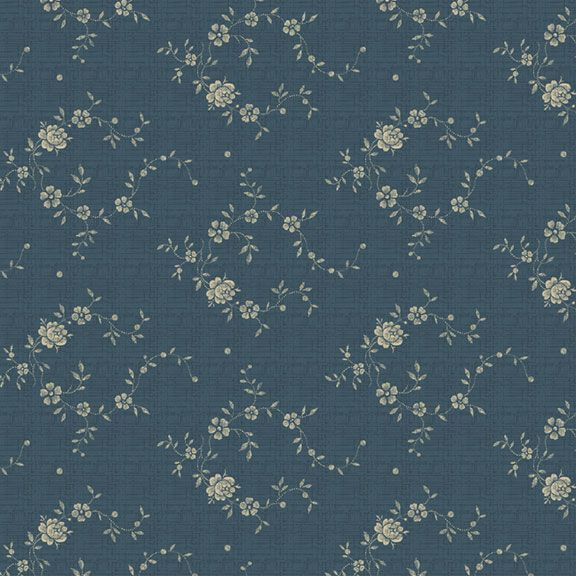 A close-up of a blue-gray fabric with a repeating cream floral and vine pattern.