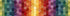 A close-up of a quilted fabric pattern featuring hexagonal patches arranged in a rainbow gradient of green, blue, purple, red, orange, and yellow, with various floral and geometric patchwork designs.