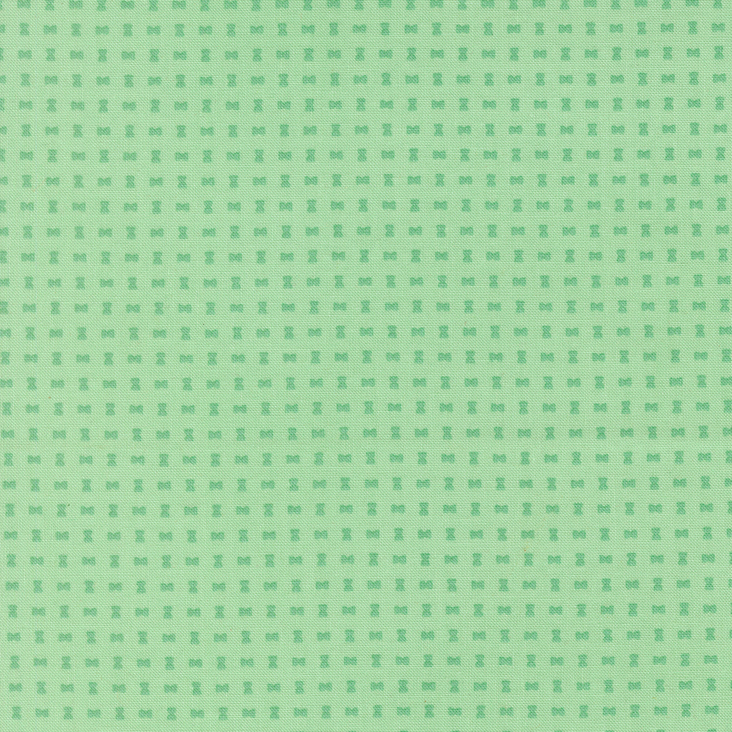Green patterned fabric with small geometric design