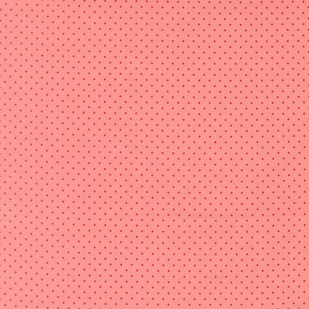 Pink fabric with small red polka dots