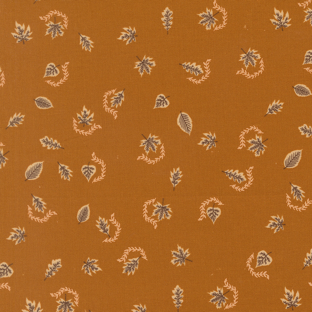 Pattern of leaves and wreaths on a brown fabric background
