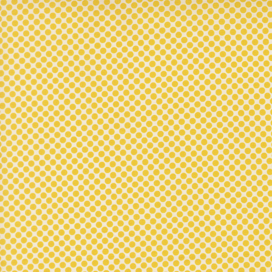Yellow fabric with small polka dot pattern