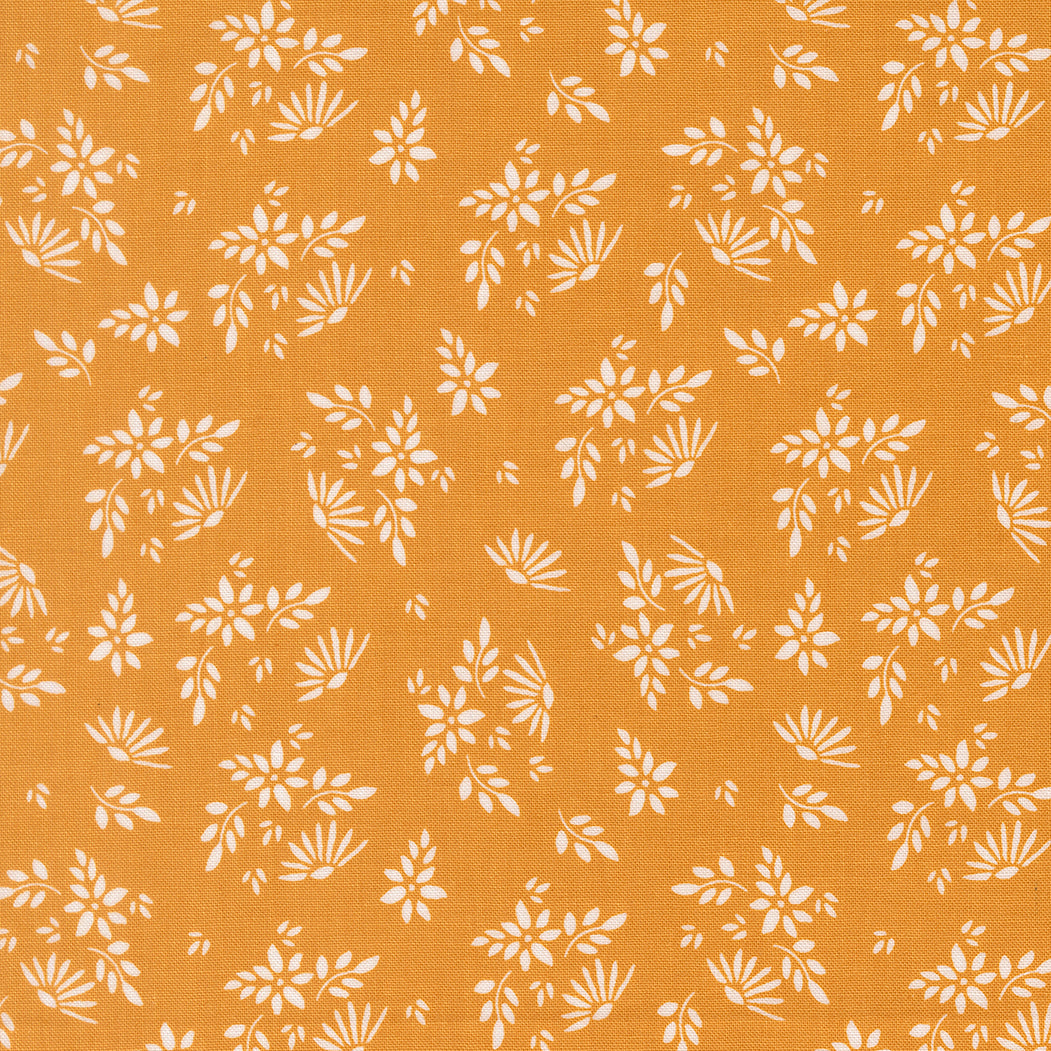 White floral pattern on a mustard yellow background