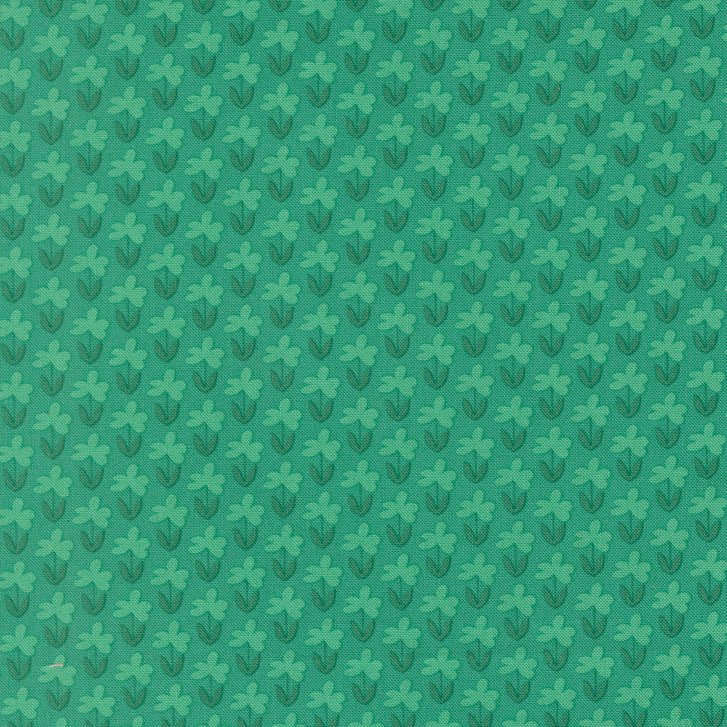 Green fabric with a subtle floral pattern