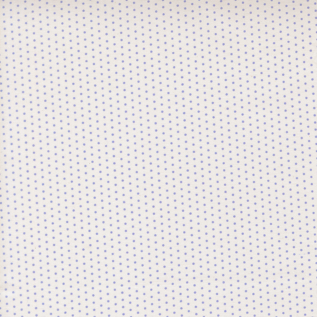 White fabric with small blue polka dots