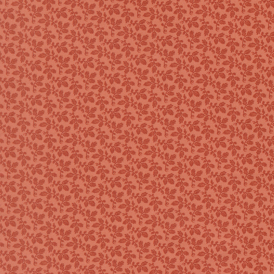 A close-up of a repeating floral pattern in muted terracotta red on a warm peach-beige background.