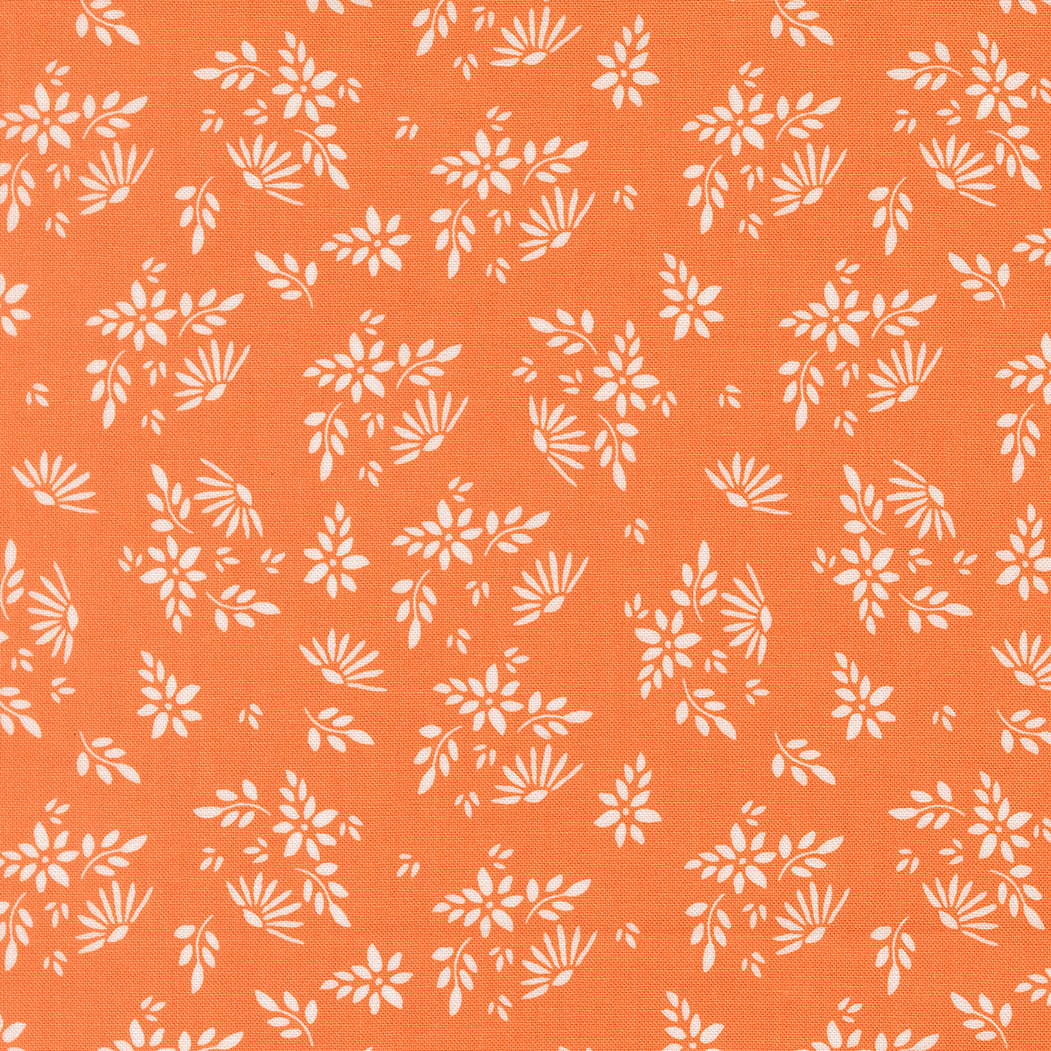 White floral pattern on an orange fabric background