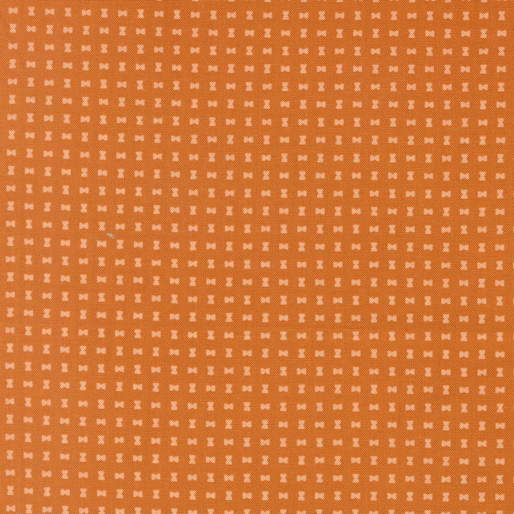 Orange patterned fabric with small geometric shapes