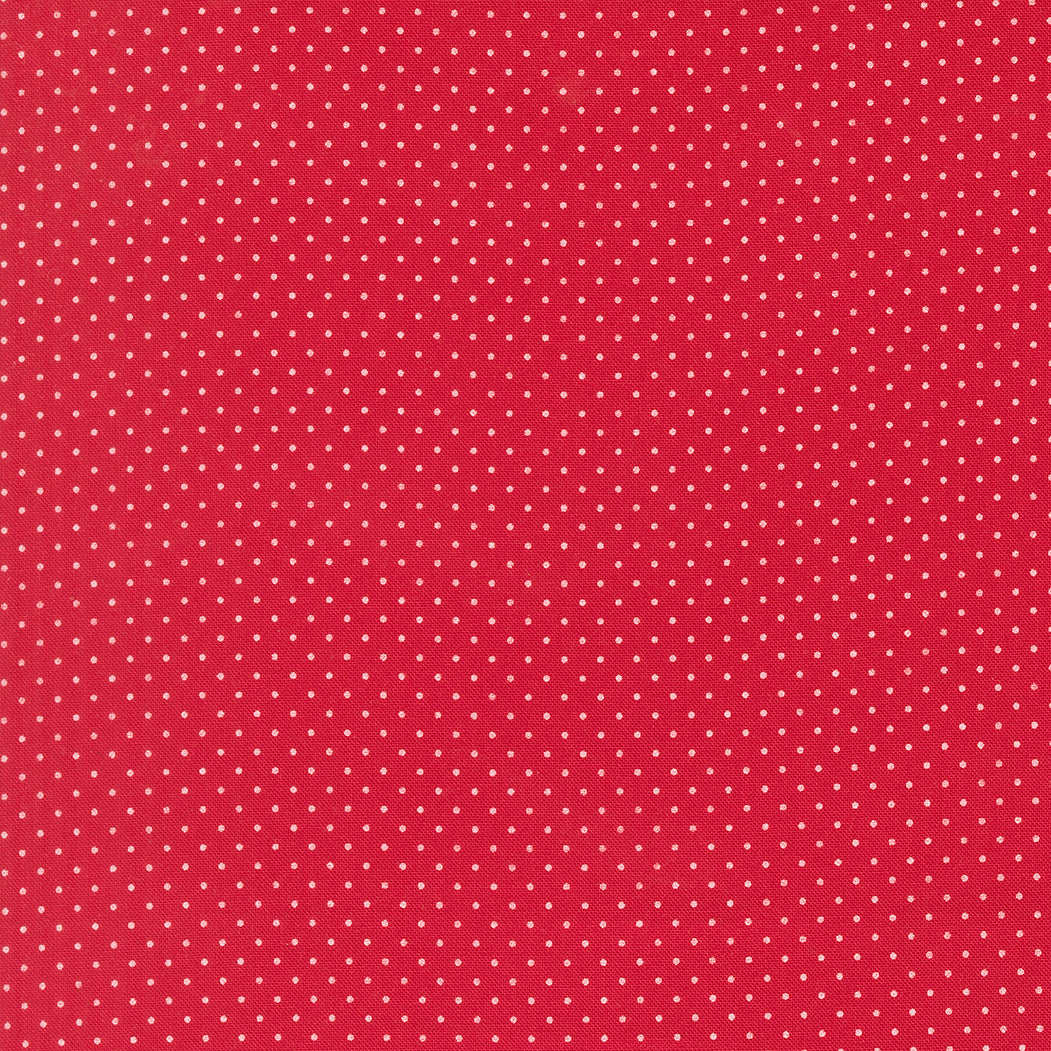 Red fabric with small white polka dots
