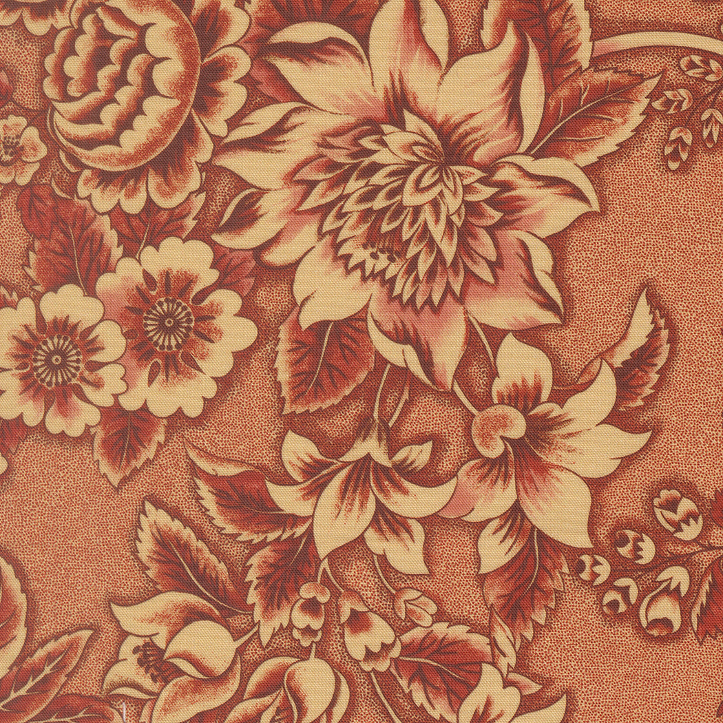 A close-up of a floral patterned material featuring large cream and rust-brown flowers with dark reddish-brown leaves on a warm tan textured background.