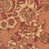 A close-up of a floral patterned material featuring large cream and rust-brown flowers with dark reddish-brown leaves on a warm tan textured background.