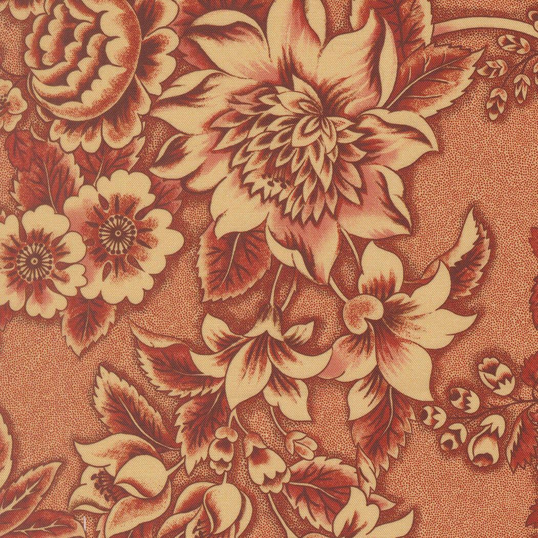 A close-up of a floral patterned material featuring large cream and rust-brown flowers with leaves on a textured tan background.