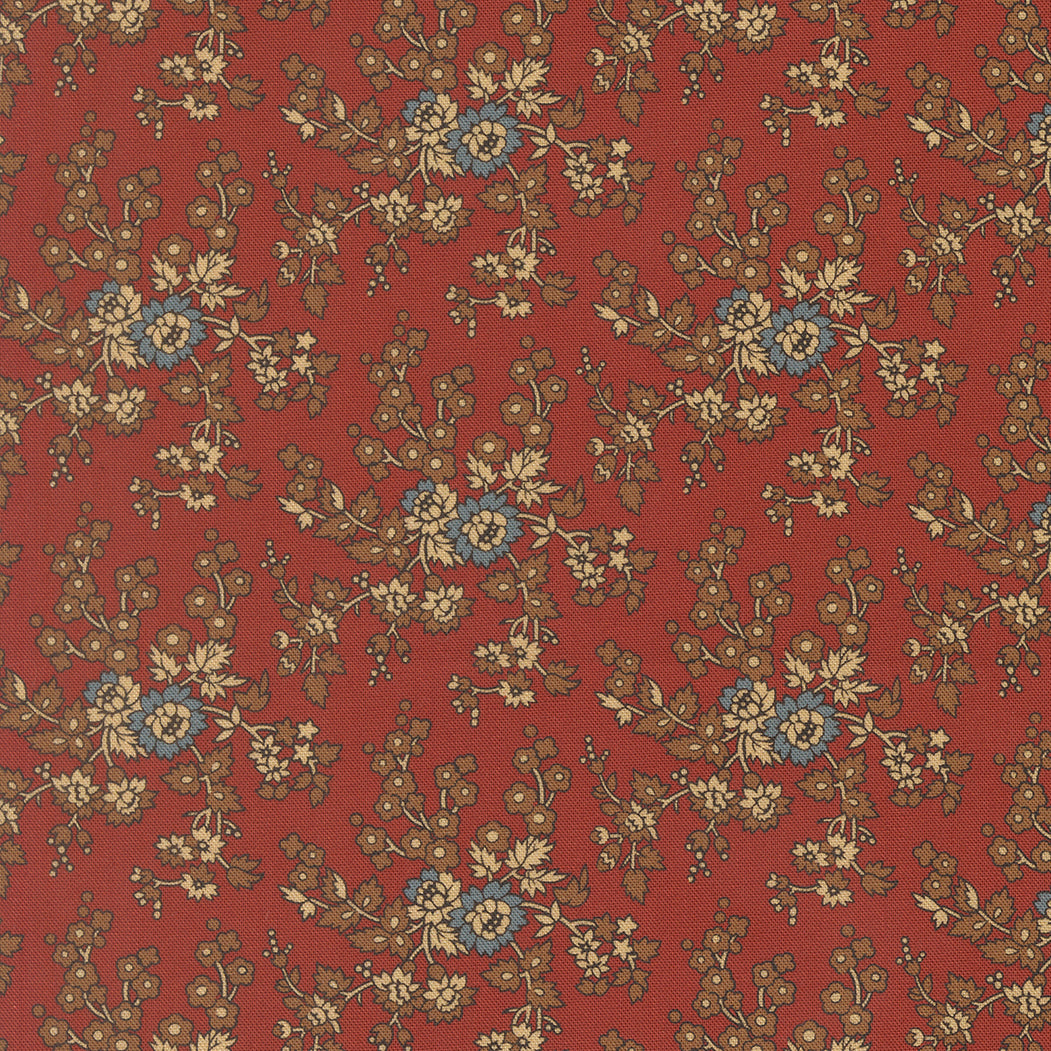 A close-up of a fabric pattern featuring a repeating floral design on a muted red background, with beige leaves and stems and small blue flower accents.