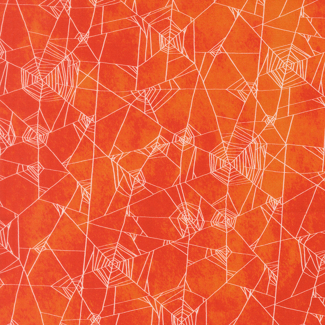 Pattern of white spider webs on a textured orange background
