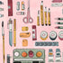 A flat-lay illustration of various stationery and art supplies on a light pink background, including colored pencils, scissors, pens, erasers, washi tape, paint tubes, and a palette.