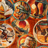 A close-up of a repeating pattern featuring circular western-themed illustrations in warm earth tones, including horses, cacti, suns, and desert landscapes on an orange-brown textured background.