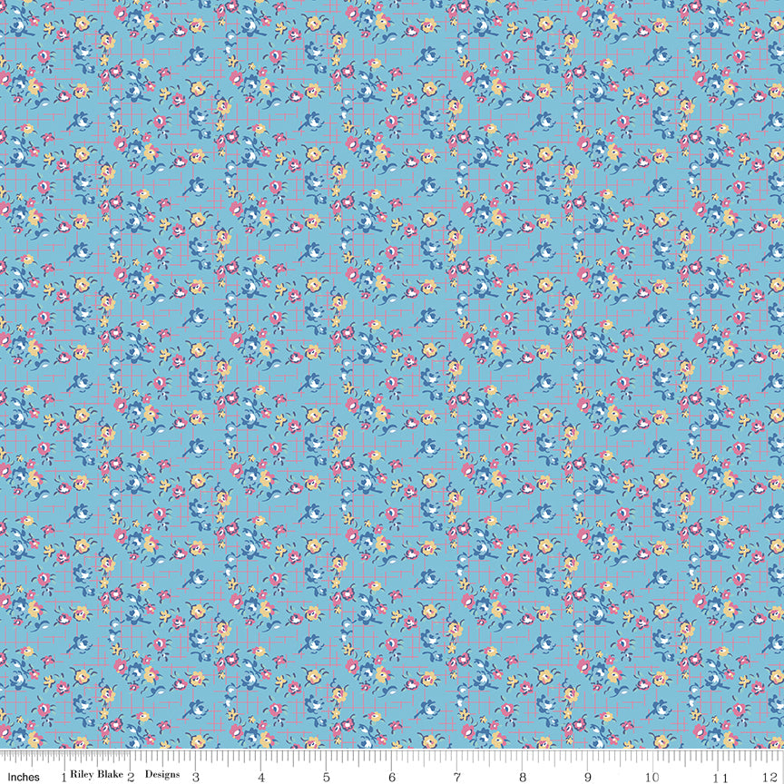 Floral pattern fabric on a blue background with a ruler at the bottom.