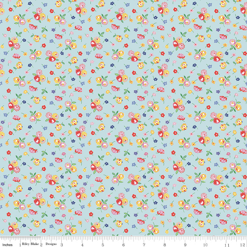 Floral pattern fabric with a ruler at the bottom on a light blue background