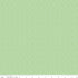 A close-up fabric pattern swatch showing a light sage green background with a repeating small white floral or ditsy dot motif. A ruler along the bottom edge shows measurements in inches and includes the text 'Riley Blake Boutique', indicating the brand.