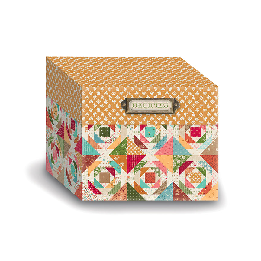 A decorative recipe box with a quilted pattern on the lower half and a small metal label reading 'RECIPES' on the front, shown on a white background.