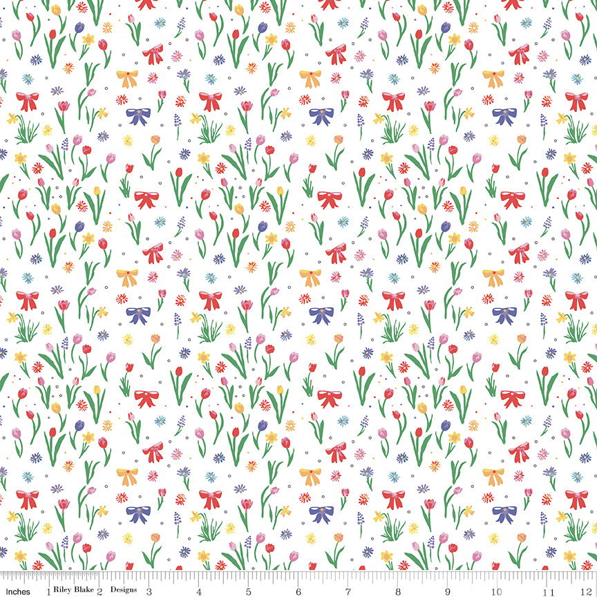 Pattern of flowers and bows on a white background with a ruler at the bottom.