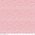 Pink fabric with white polka dots and a ruler at the bottom