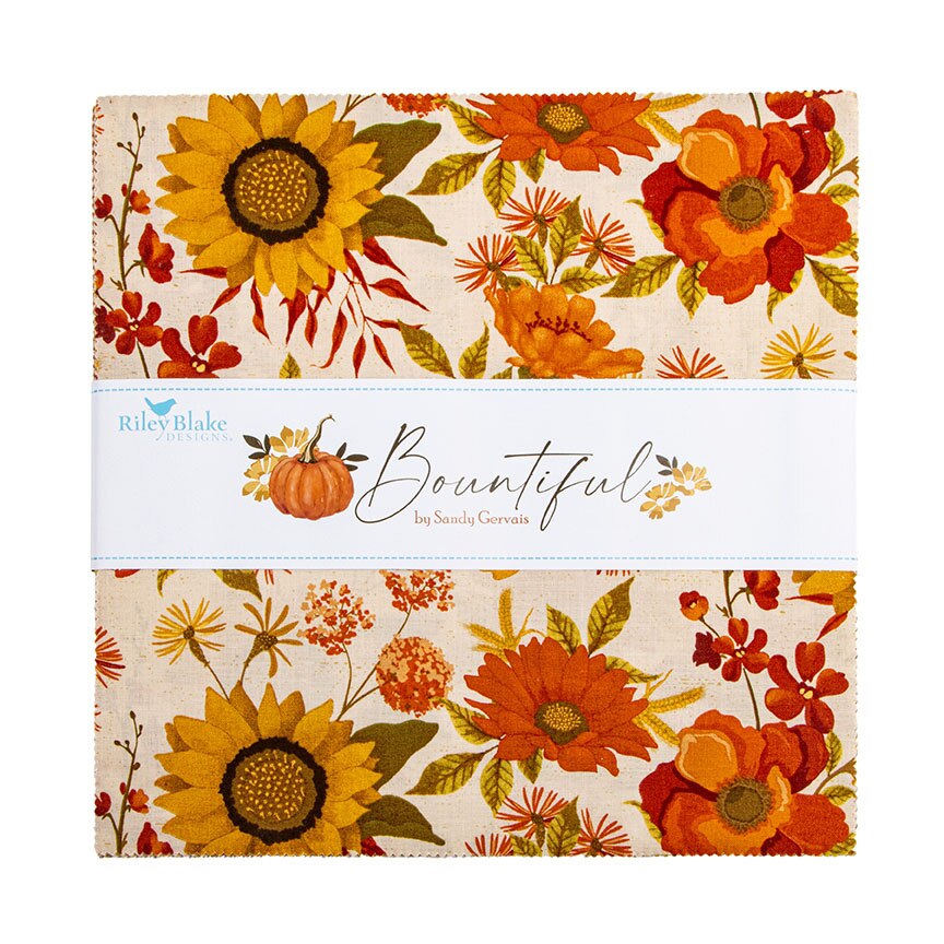 A folded fabric cloth featuring a warm autumn floral pattern with sunflowers, orange flowers, red berries, and a small pumpkin on a cream background. A white paper band across the middle reads 'Riley Blake Designs' and 'Bountiful by Sandra Gervais.