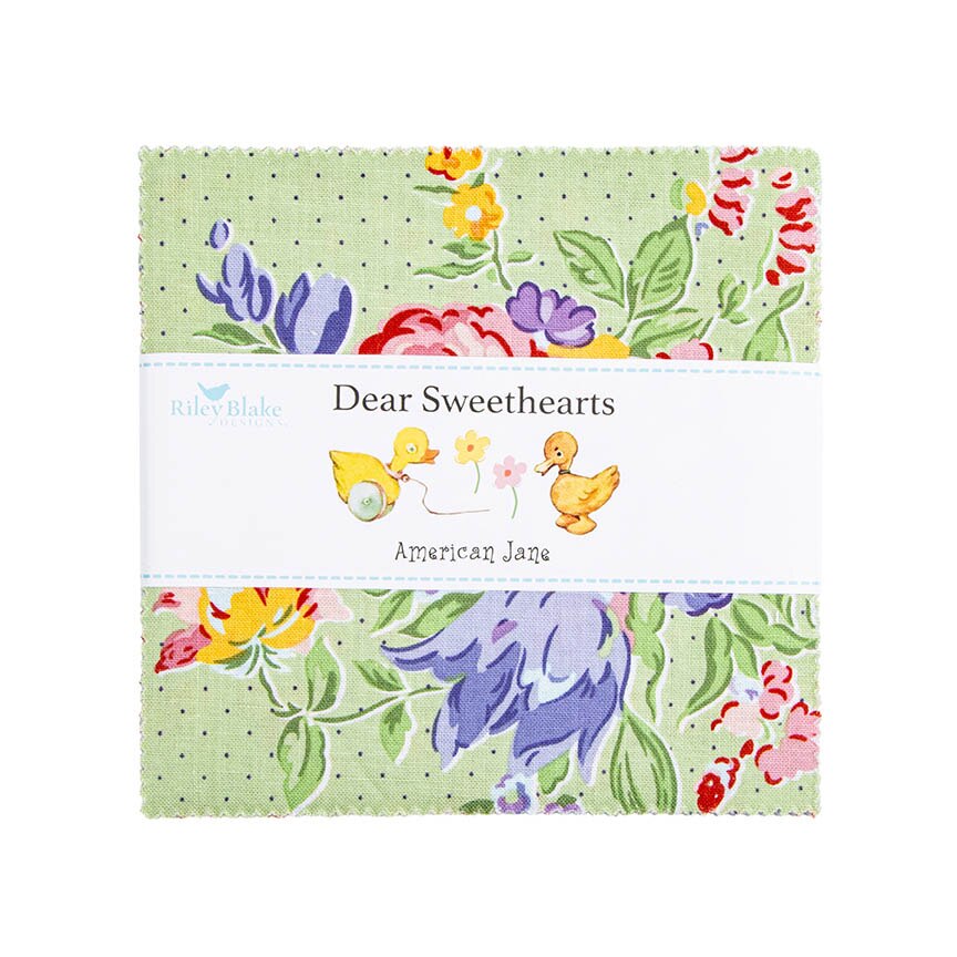 A folded fabric bundle wrapped with a white paper band reading 'Riley Blake Dear Sweethearts American Jane,' featuring a pastel floral print with green leaves, purple flowers, yellow ducks, and red and pink blossoms on a pale green dotted background.